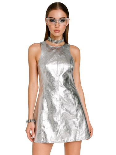 Woman wearing a silver metallic dress on a white background